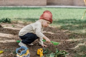 Little girl making her own garden .